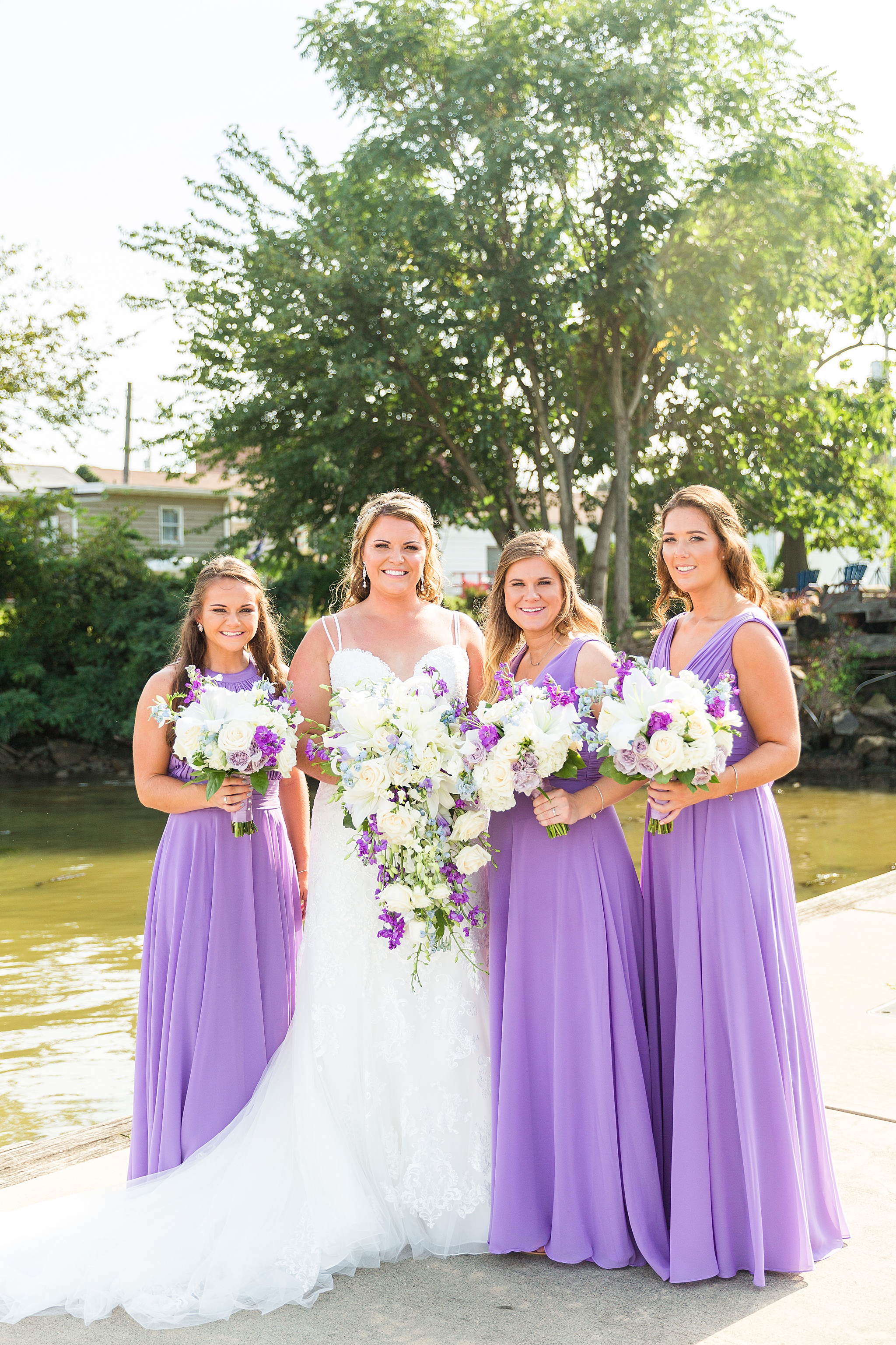 bridesmaids in lavender gowns photographed by Alexandra Mandato Photography