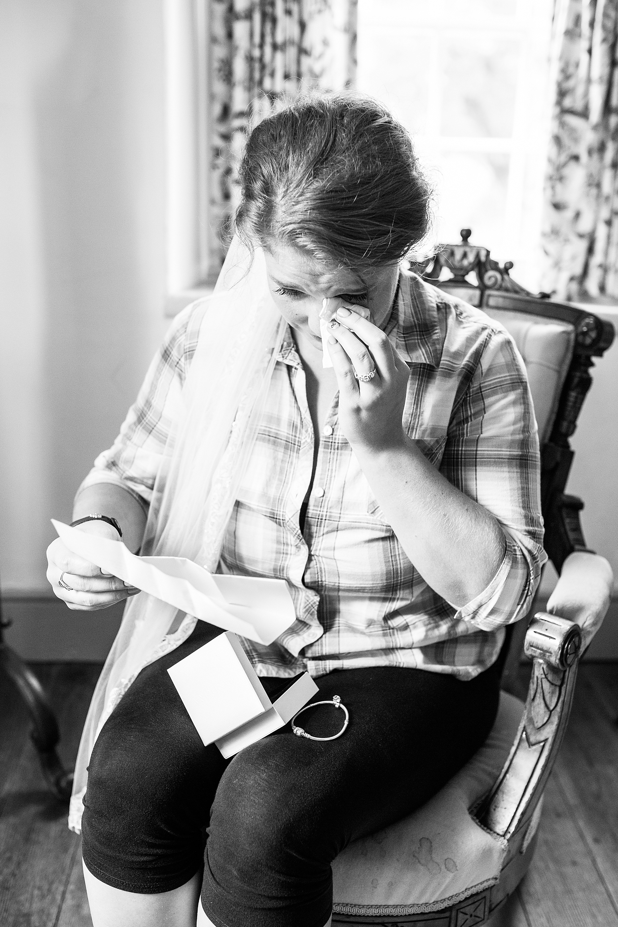 bride cries opening wedding gift photographed by Alexandra Mandato Photography