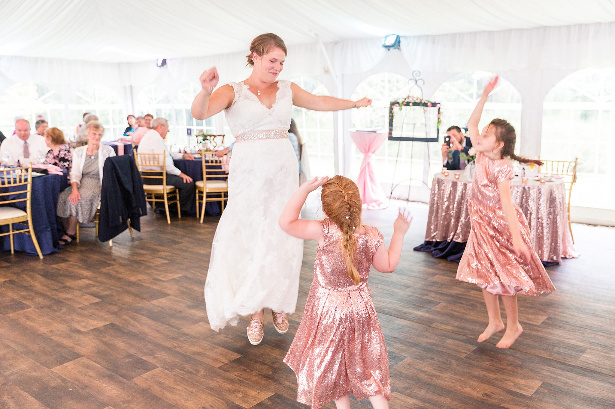 bride dances with flower girls photographed by Alexandra Mandato Photography