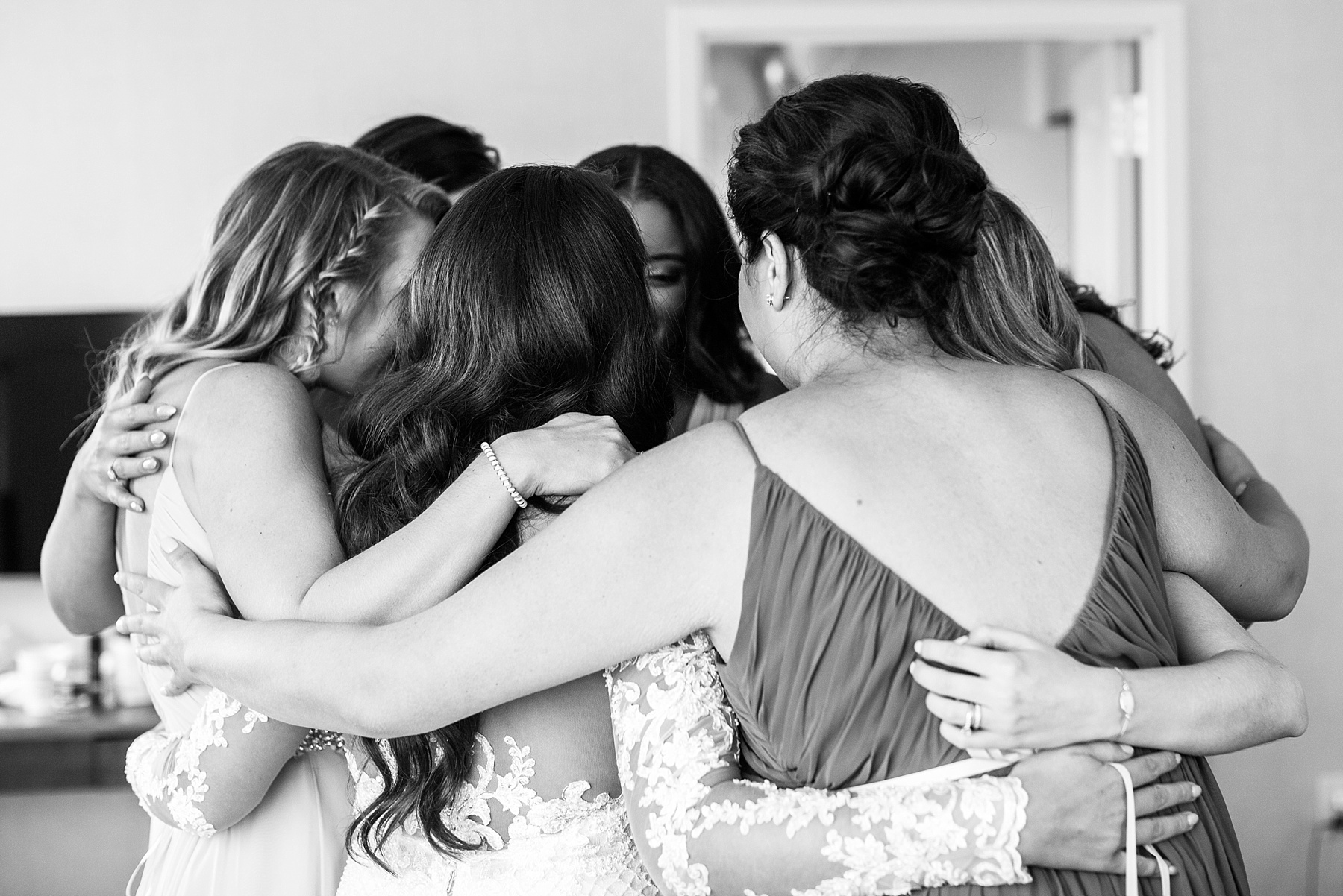 Alexandra Mandato Photography photographs bridesmaids hugging bride