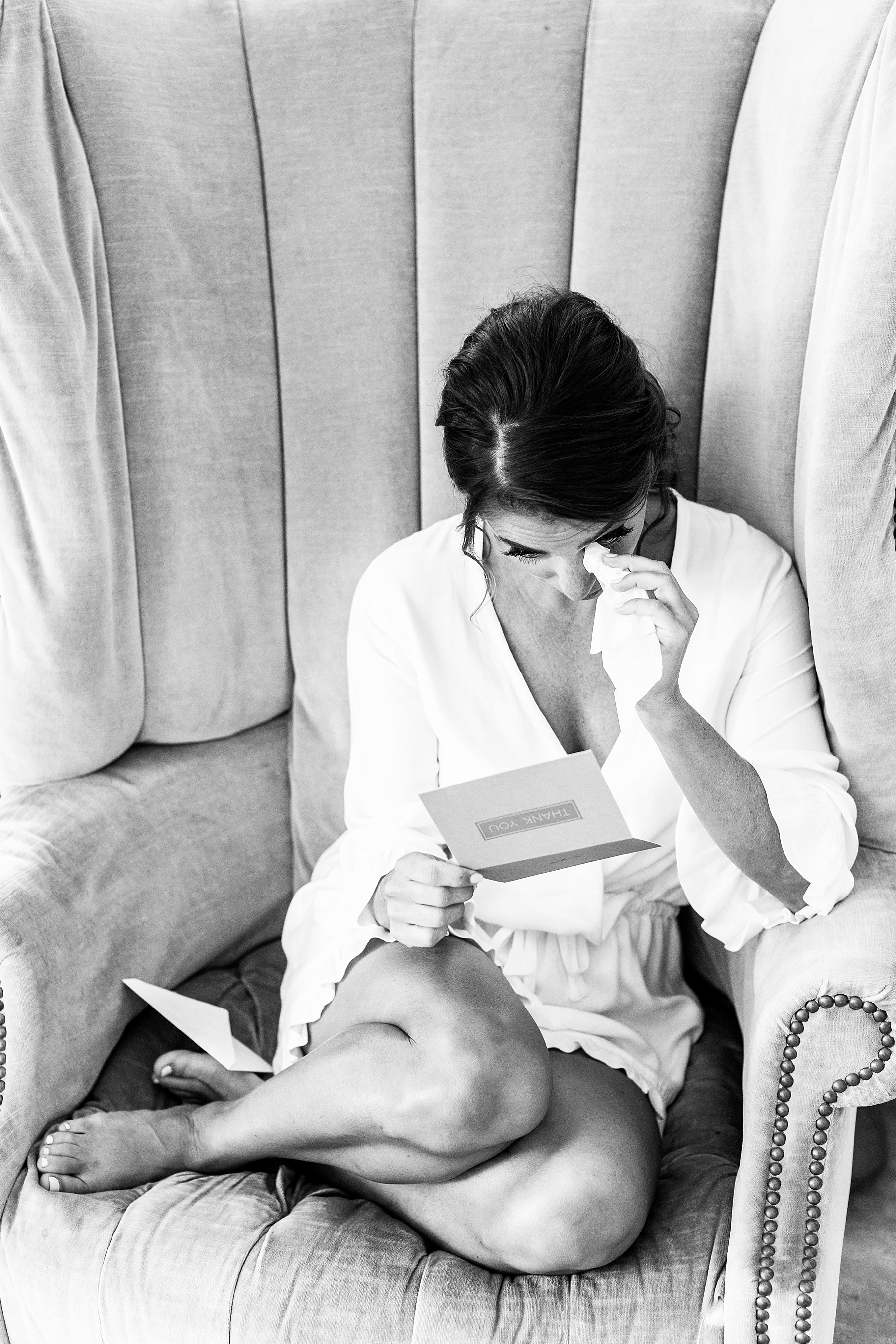 bride cries opening gift from husband on wedding day with Alexandra Mandato Photography