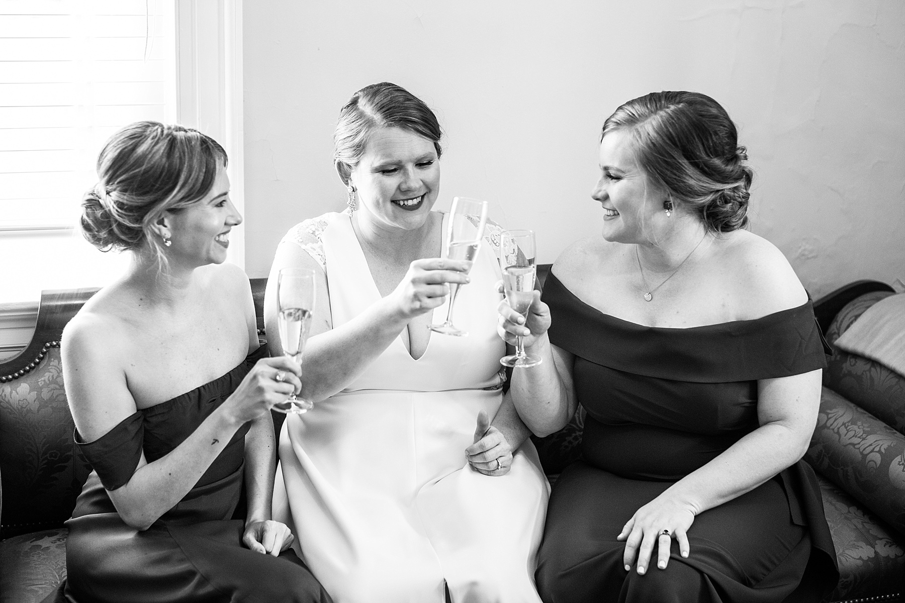bridesmaids cheer on wedding day with  Alexandra Mandato Photography