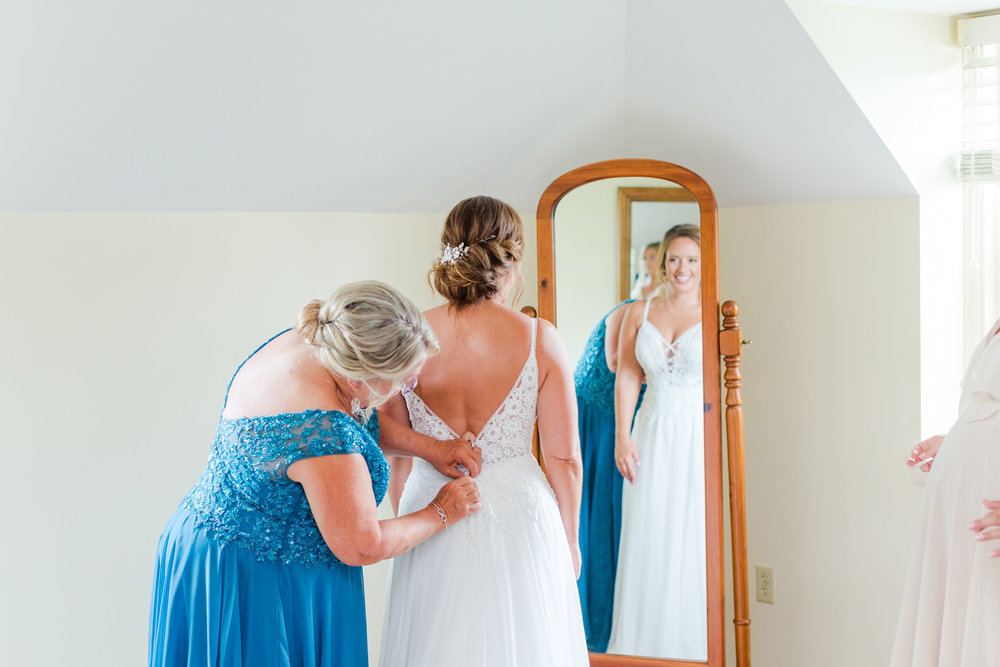 mother does buttons on wedding gown at Drumore Estate