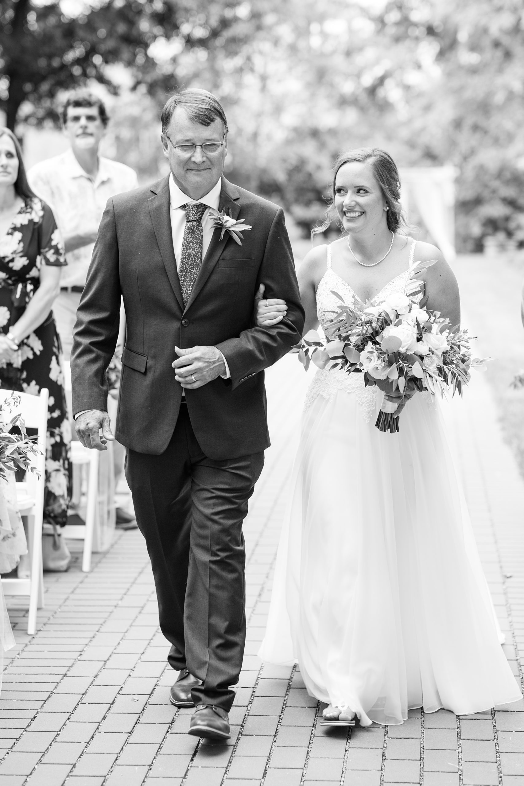 bride walks down aisle with father at Drumore Estate