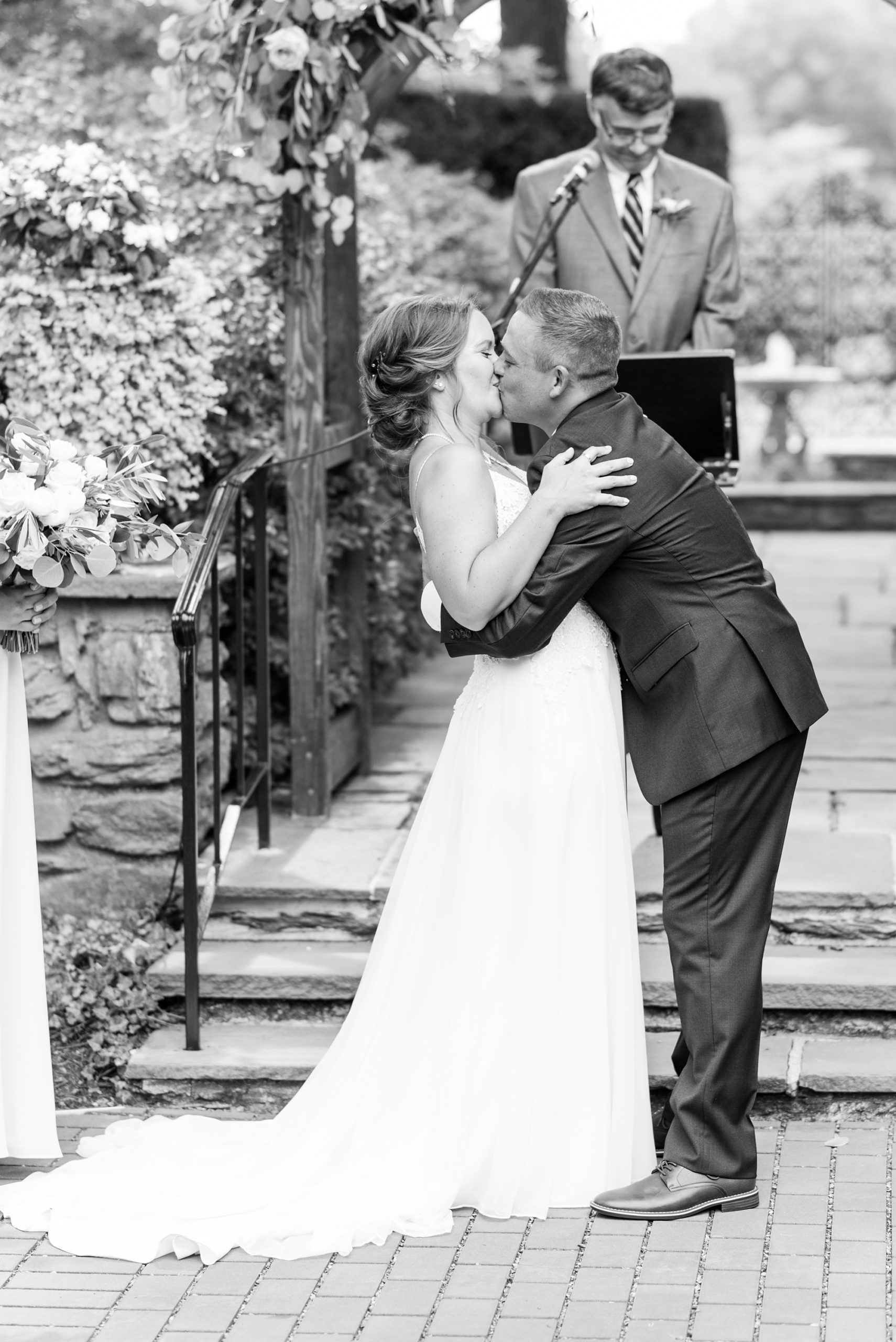 groom kisses bride during ceremony at Drumore Estate