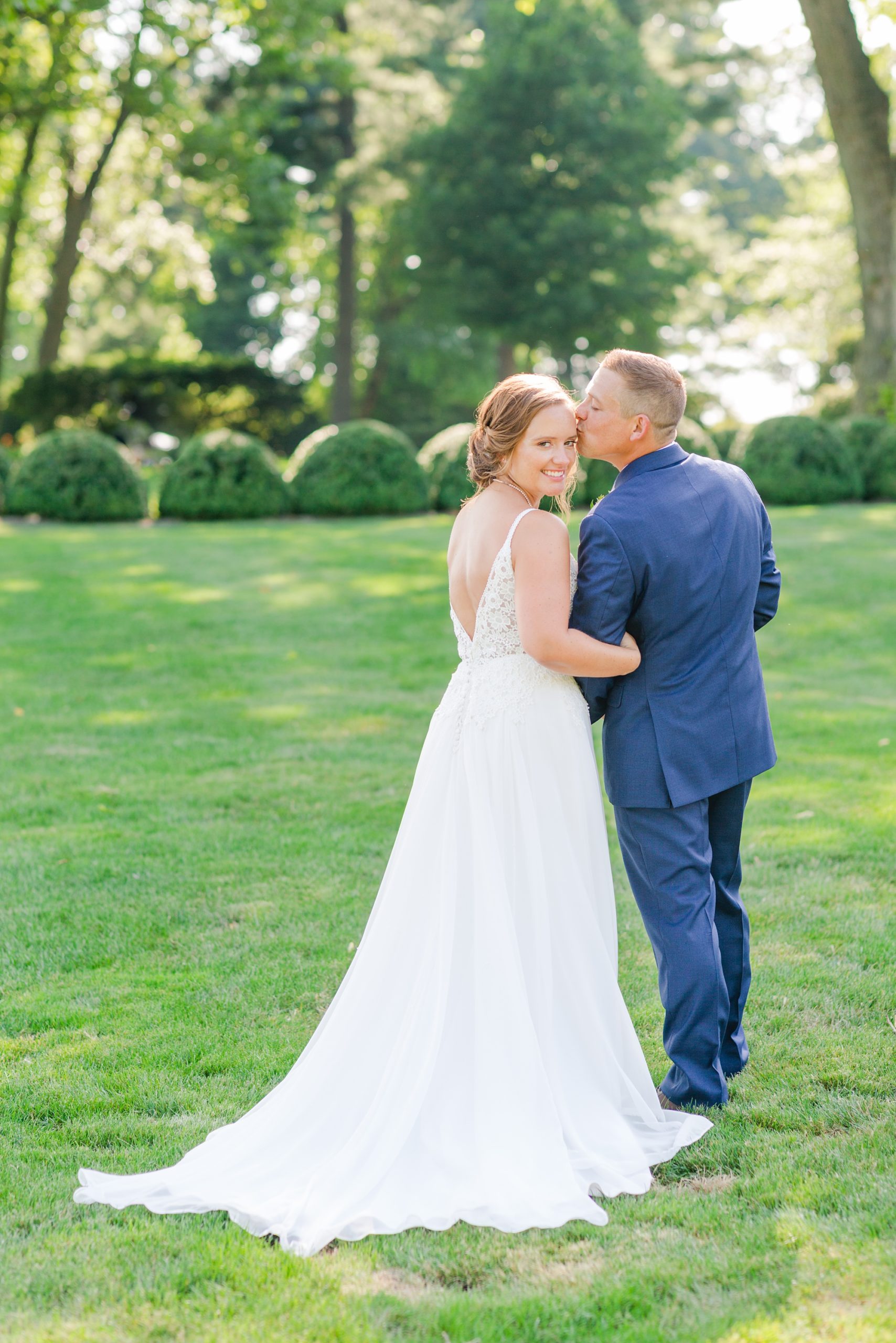 groom kisses bride's forehead during portraits at Drumore Estate