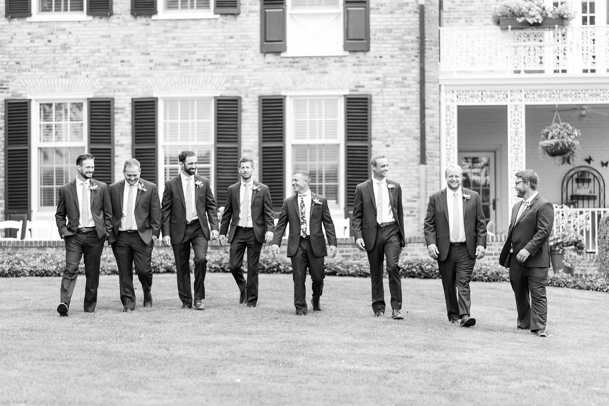 groom and groomsmen walk outside Drumore Estate