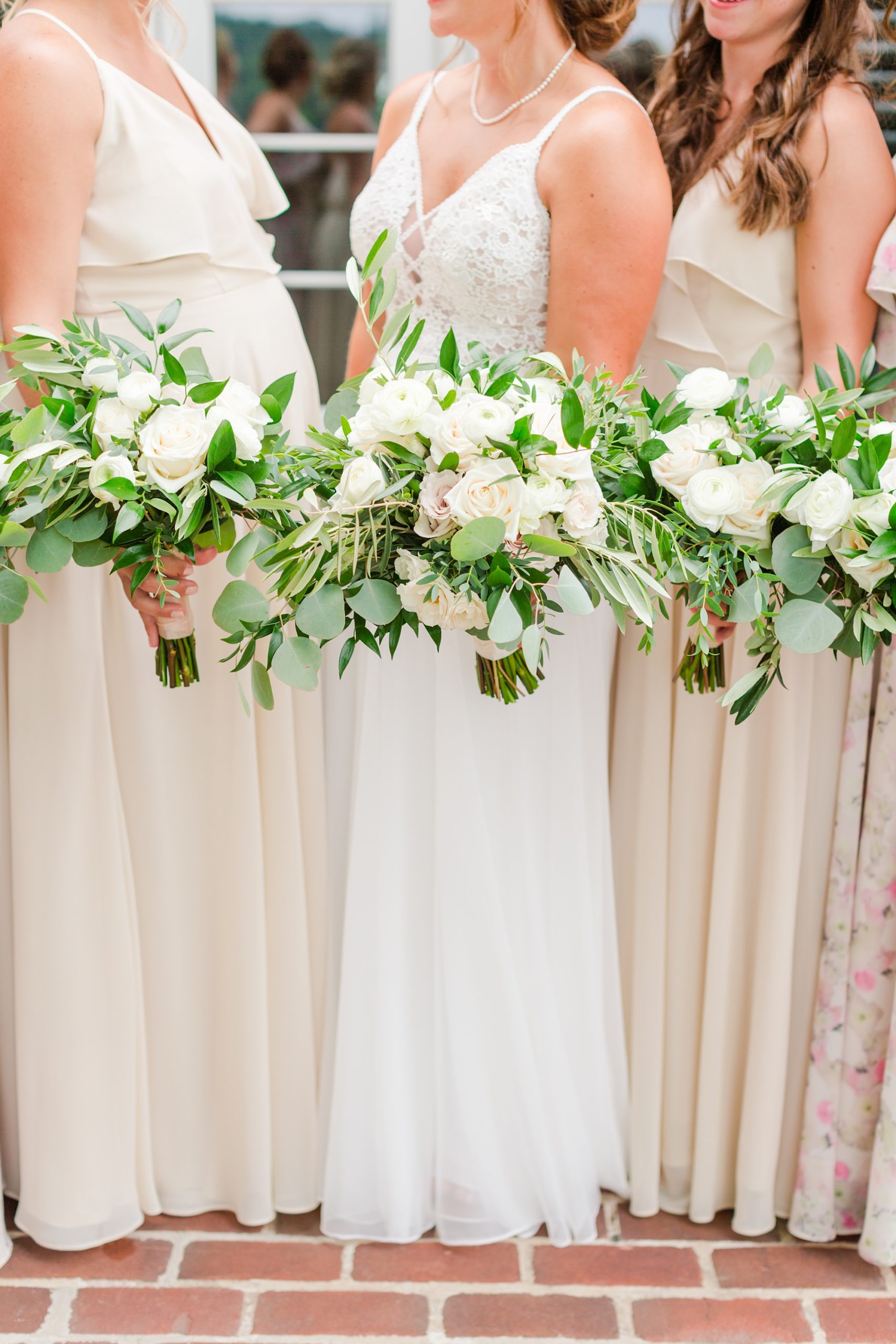 bride and bridesmaids hold pastel wedding bouquets 