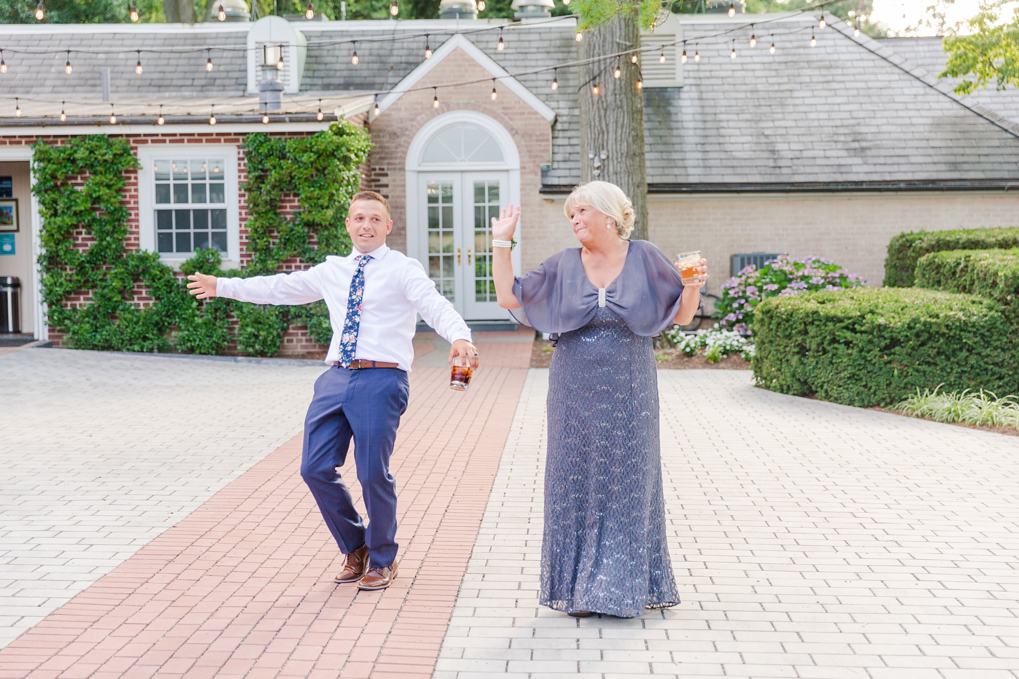 groom and mother dance on patio at Drumore Estate wedding reception