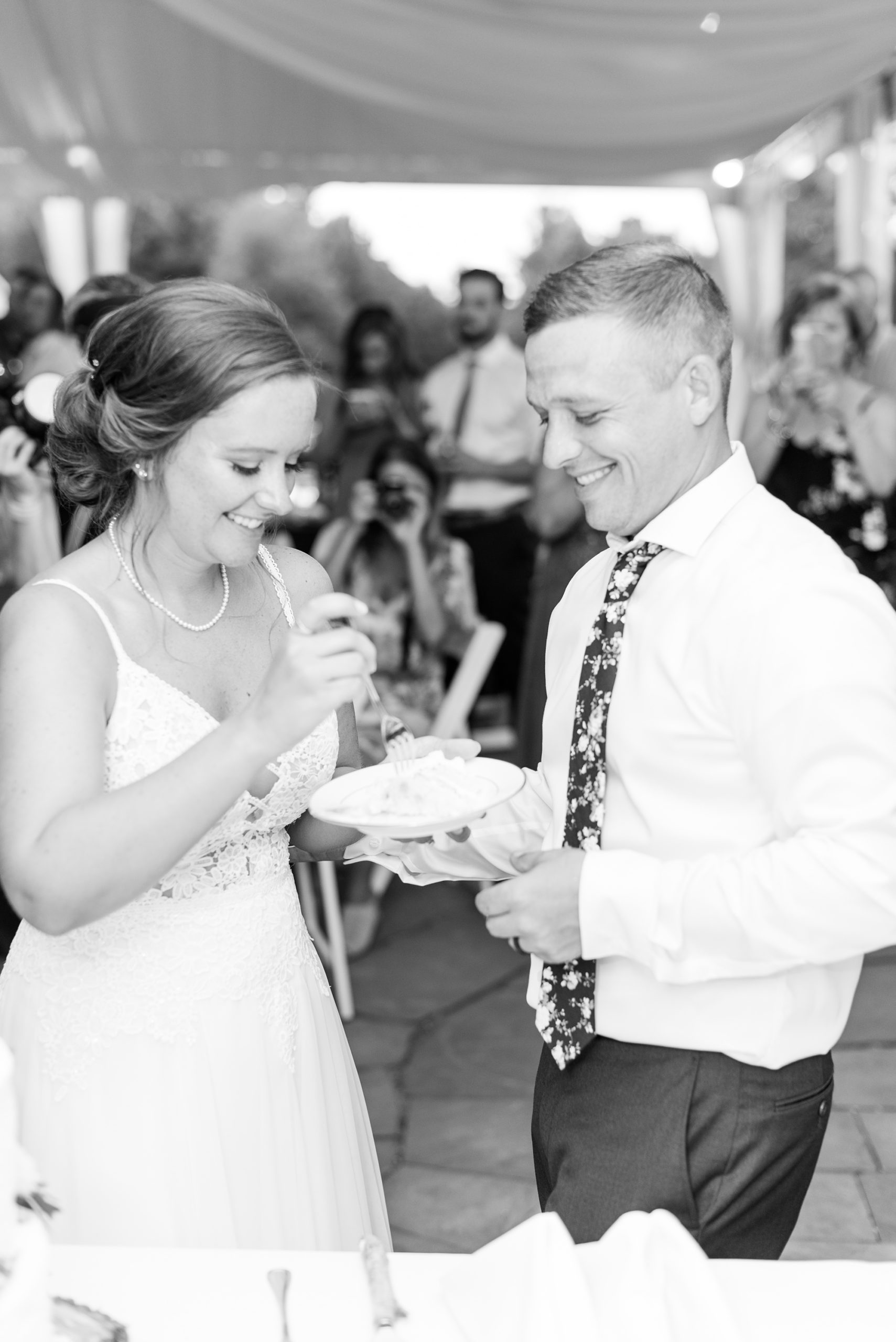 bride and groom eat wedding cake during reception in Lancaster PA