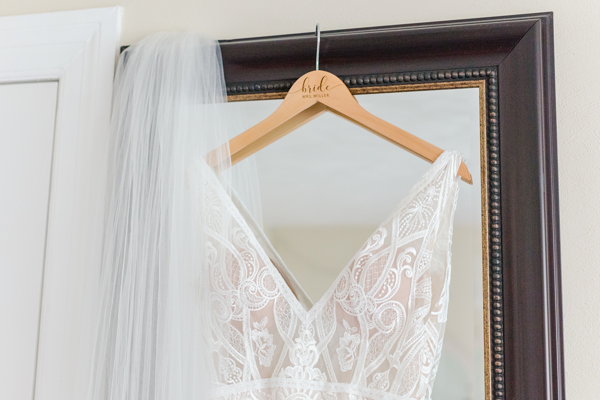 bridal gown with lace details hangs at Historic Shady Lane
