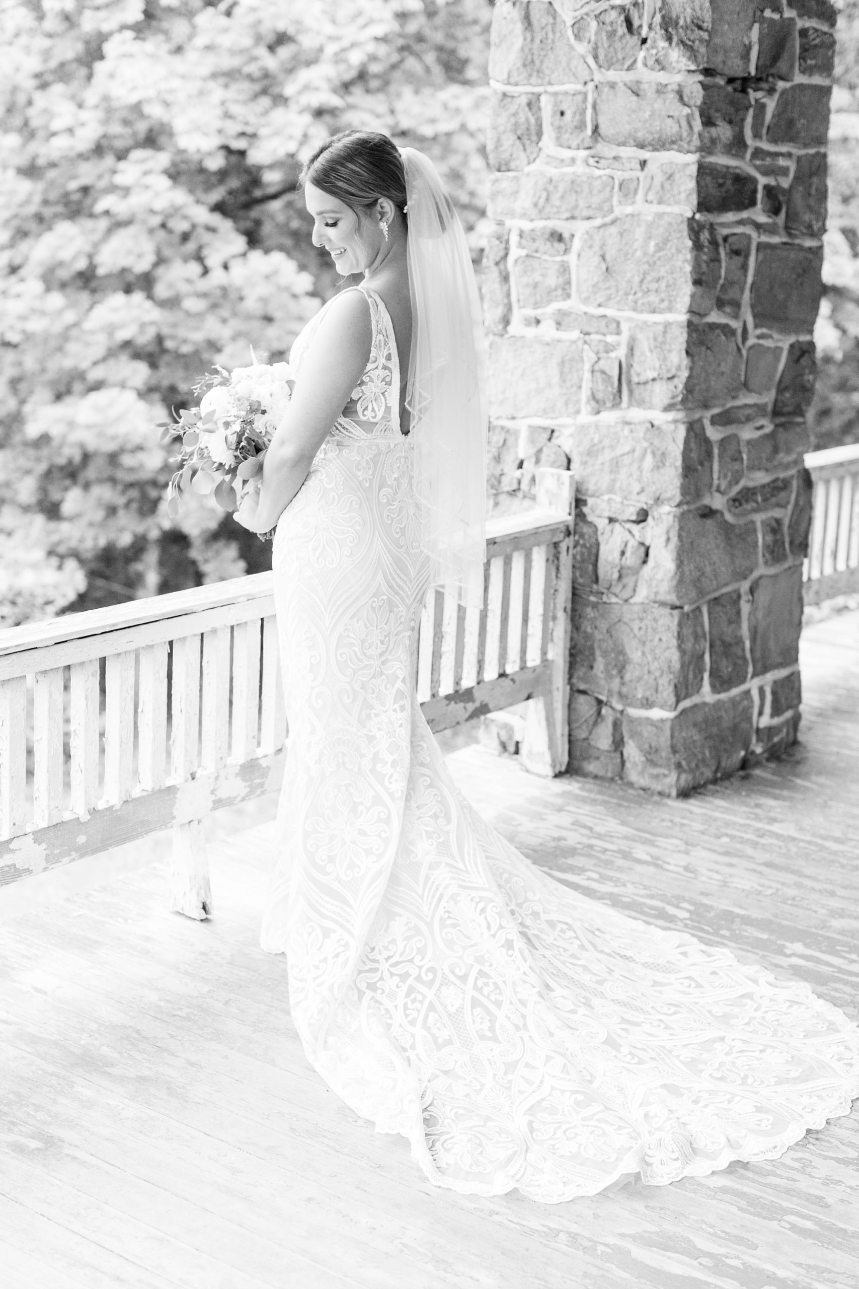bride poses on balcony overlooking Historic Shady Lane