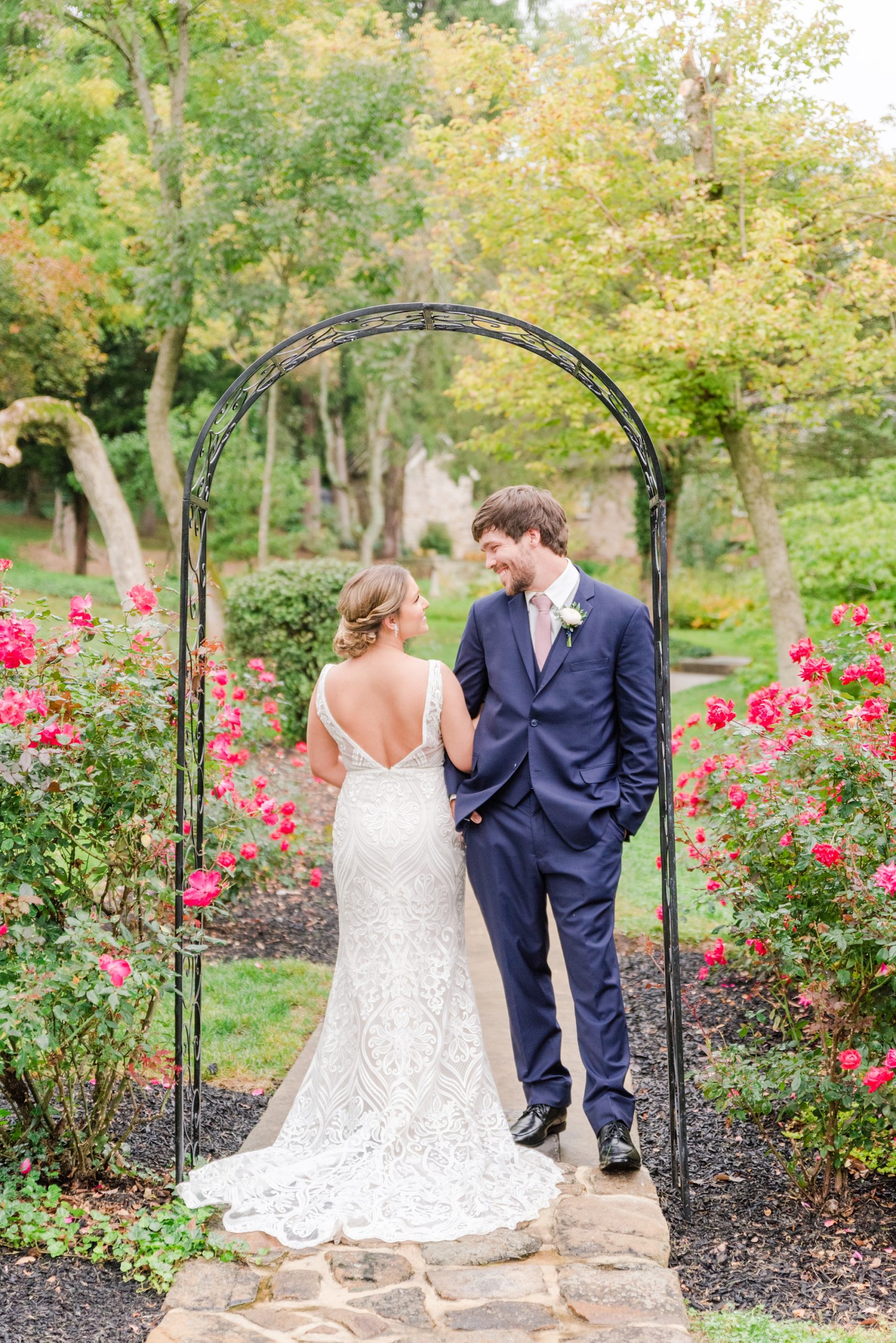 bride and groom pose under arbor at Historic Shady Lane