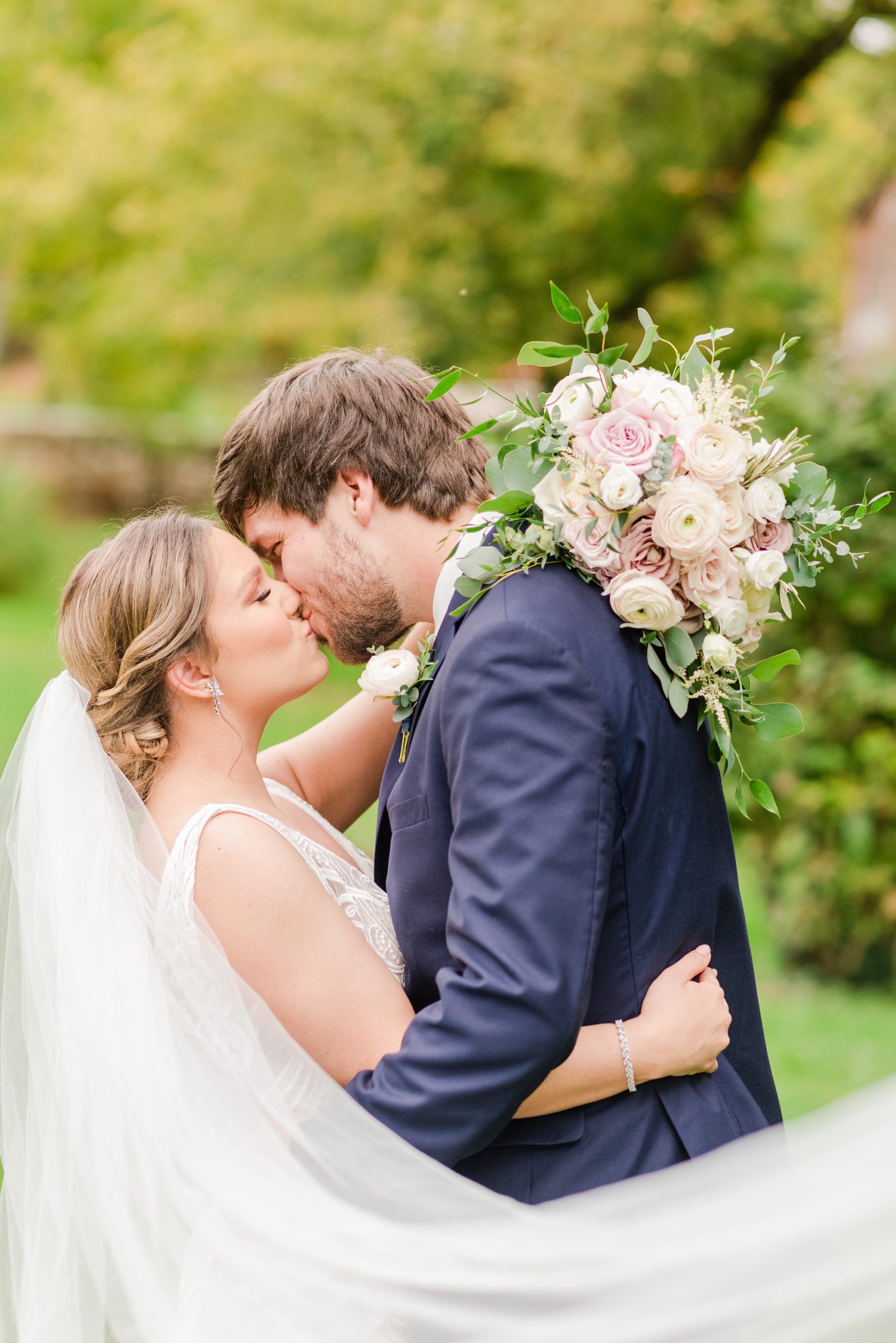 bride and groom kiss during fall wedding day at Historic Shady Lane