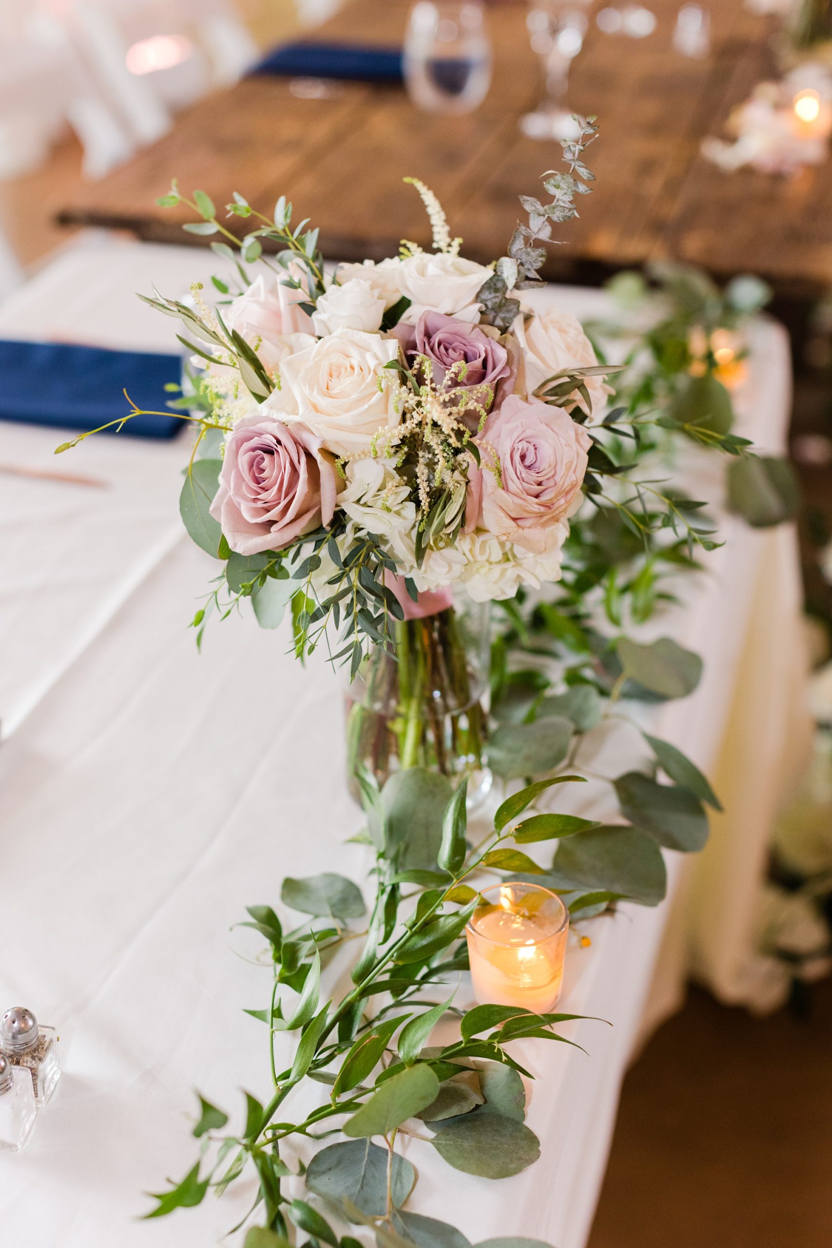 mauve and pink flowers rest on sweetheart table at Historic Shady Lane