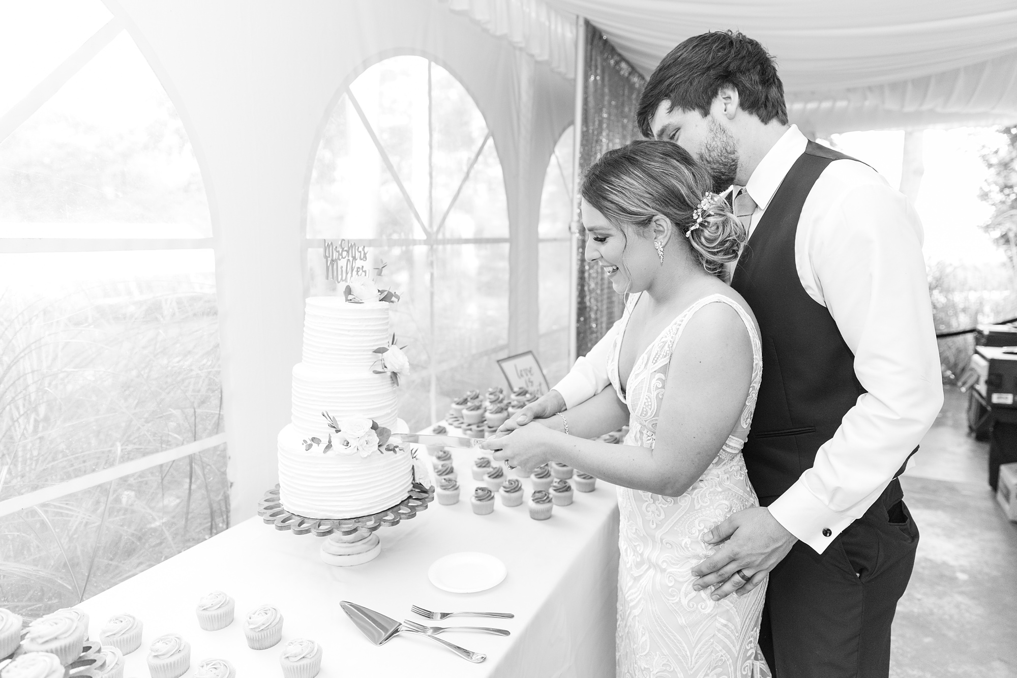 bride and groom cut wedding cake at Historic Shady Lane reception