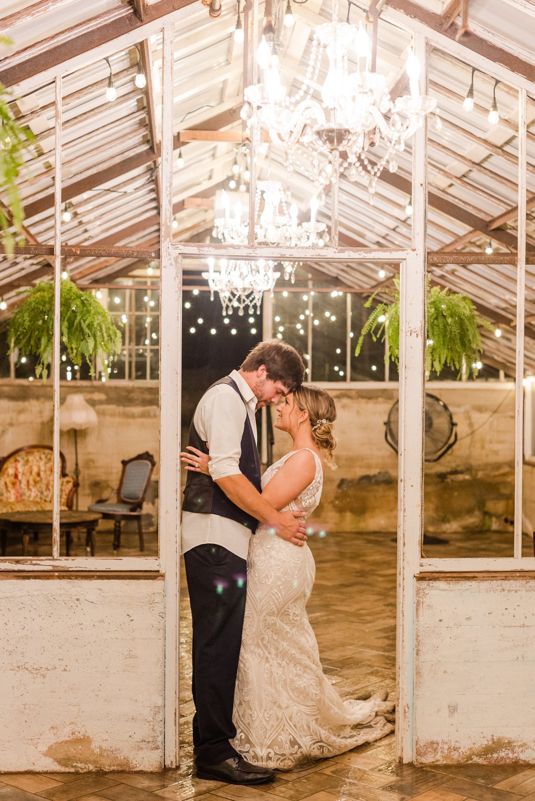 bride and groom pose in front of greenhouse at Historic Shady Lane