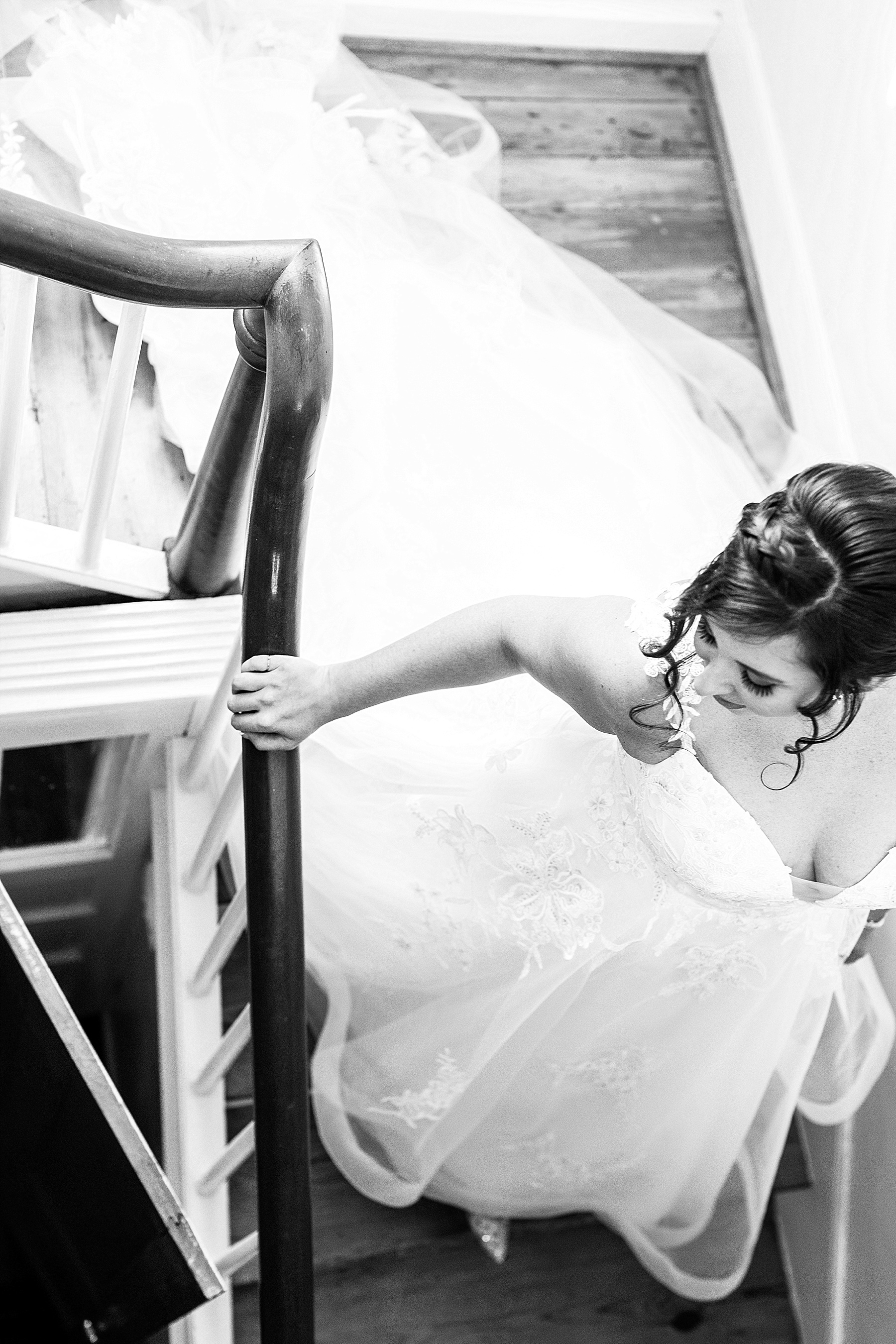 bride walks down Springfield Manor staircase for wedding with Alexandra Mandato Photography