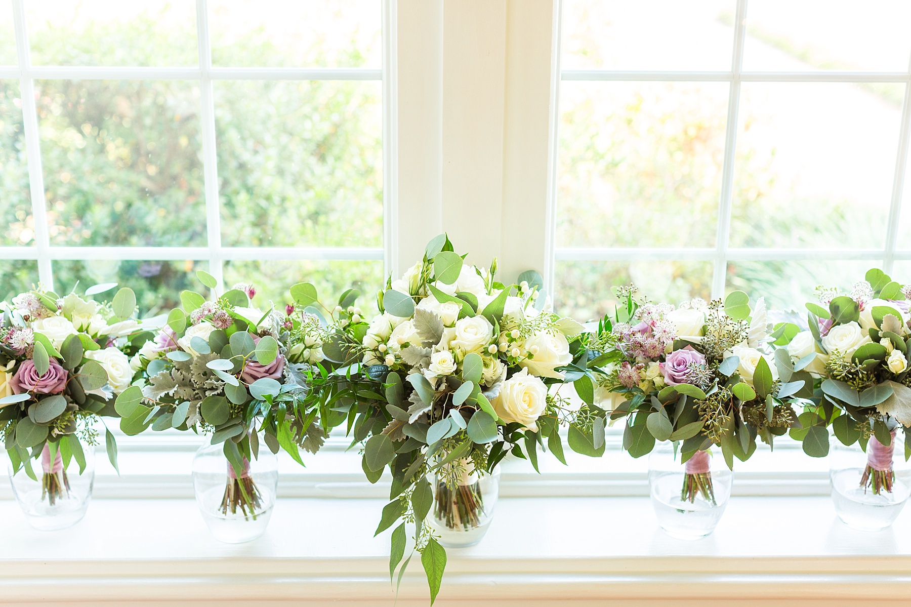 Amanda's Florist creates purple and ivory floral bouquets