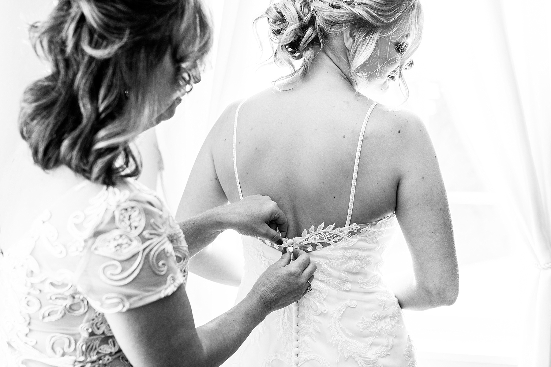 bride getting into wedding dress by Alexandra Mandato Photography
