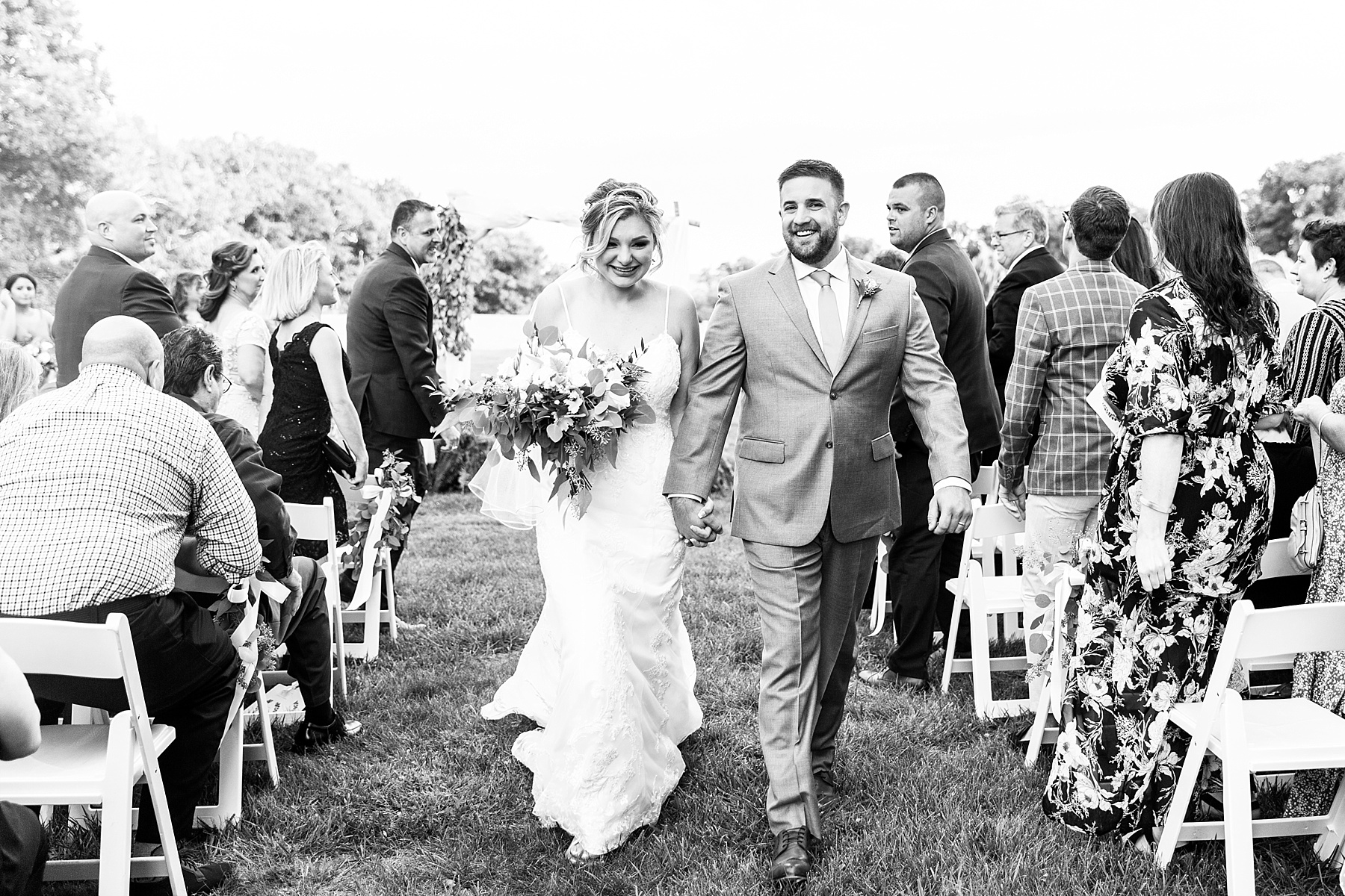 newlyweds walk up aisle photographed by Alexandra Mandato Photography