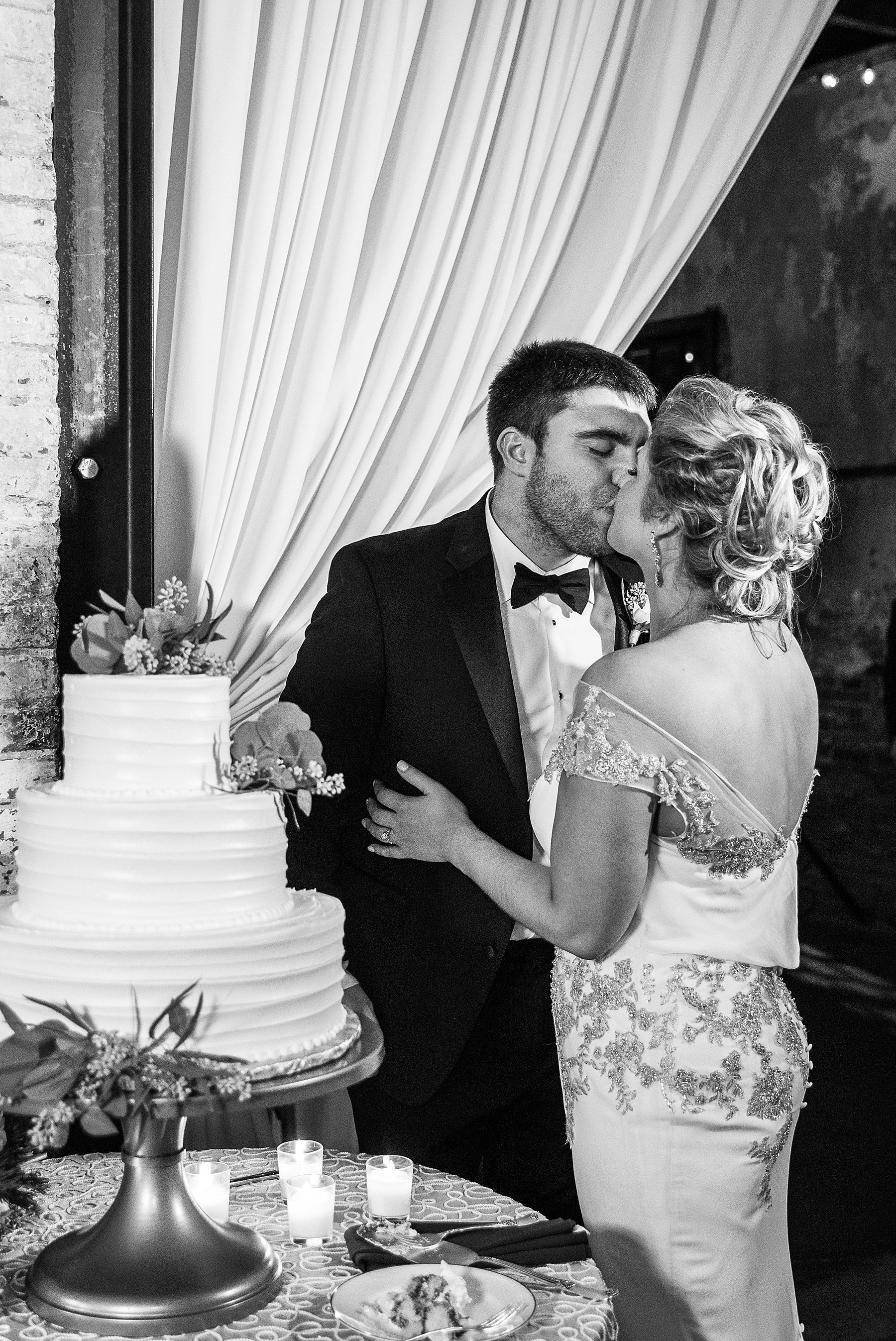 cake cutting photographed by Alexandra Mandato Photography at Mt. Washington Mill Dye House wedding