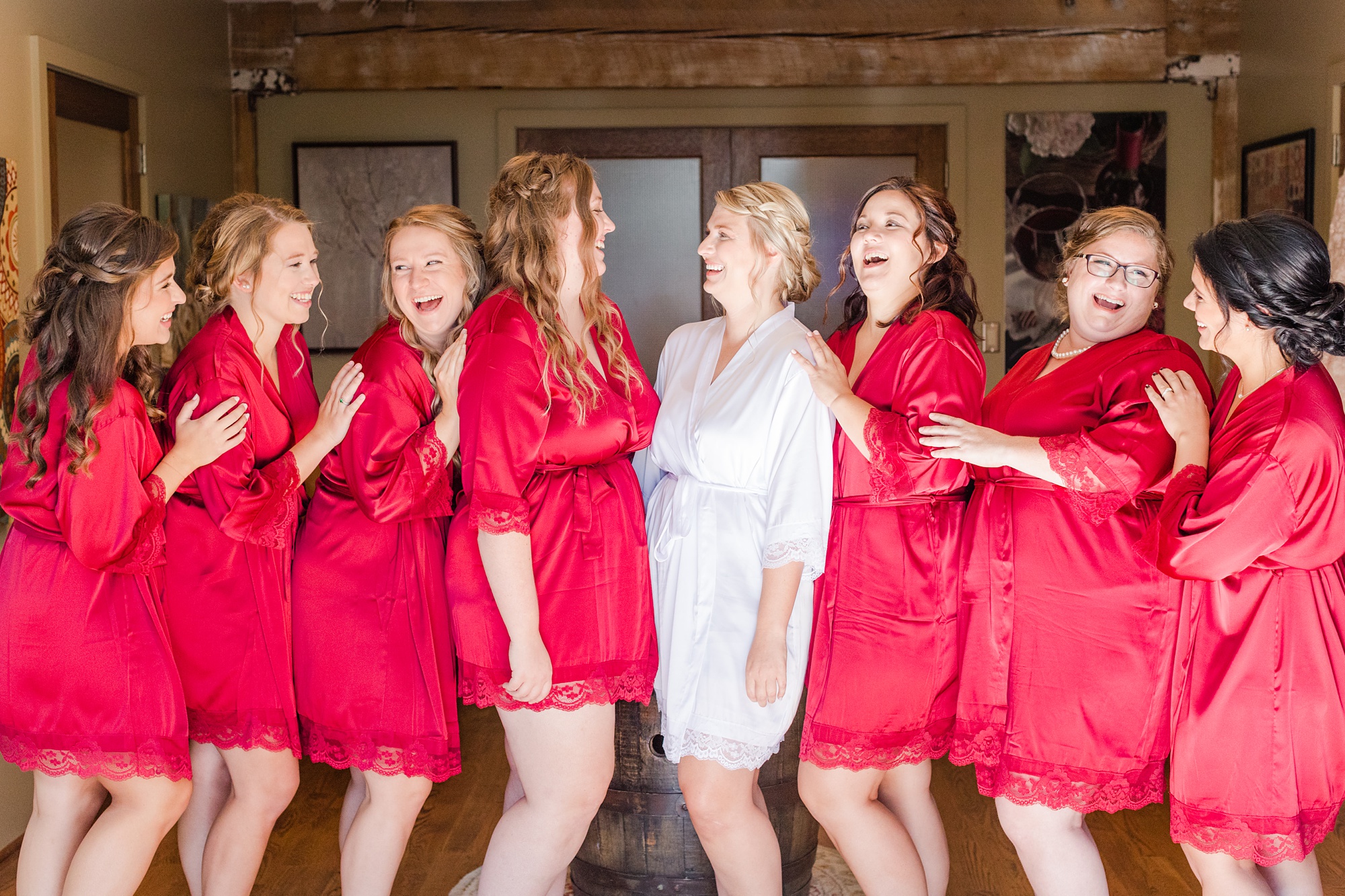 bride and bridesmaids laugh together before Iron Works House wedding
