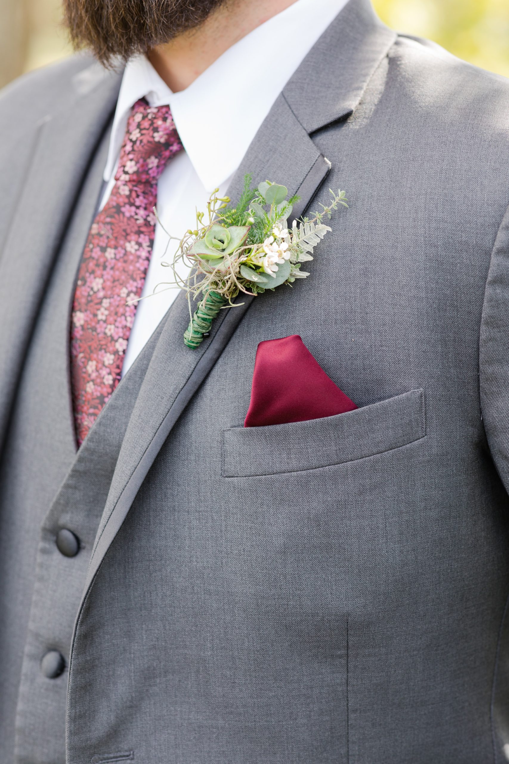 groom's details and burgundy pocket square 