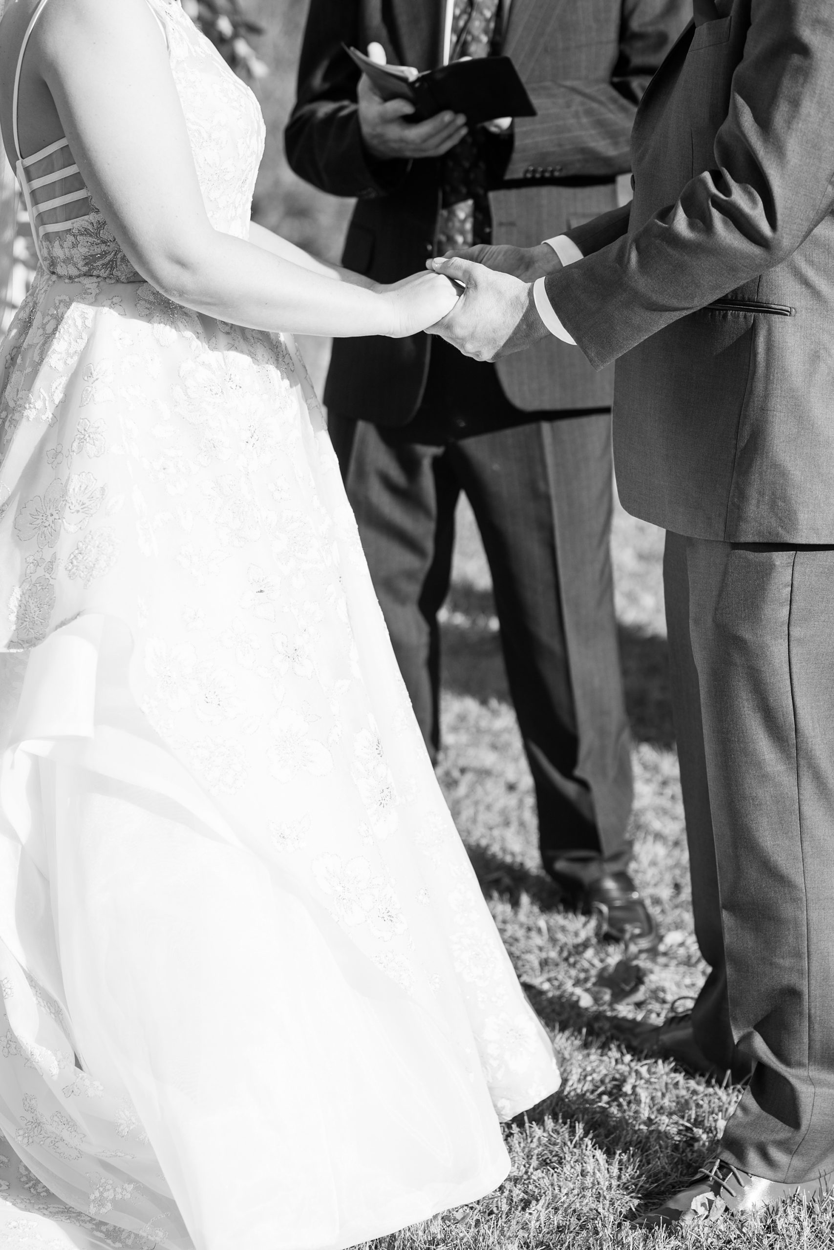 bride and groom hold hands while exchanging vows 