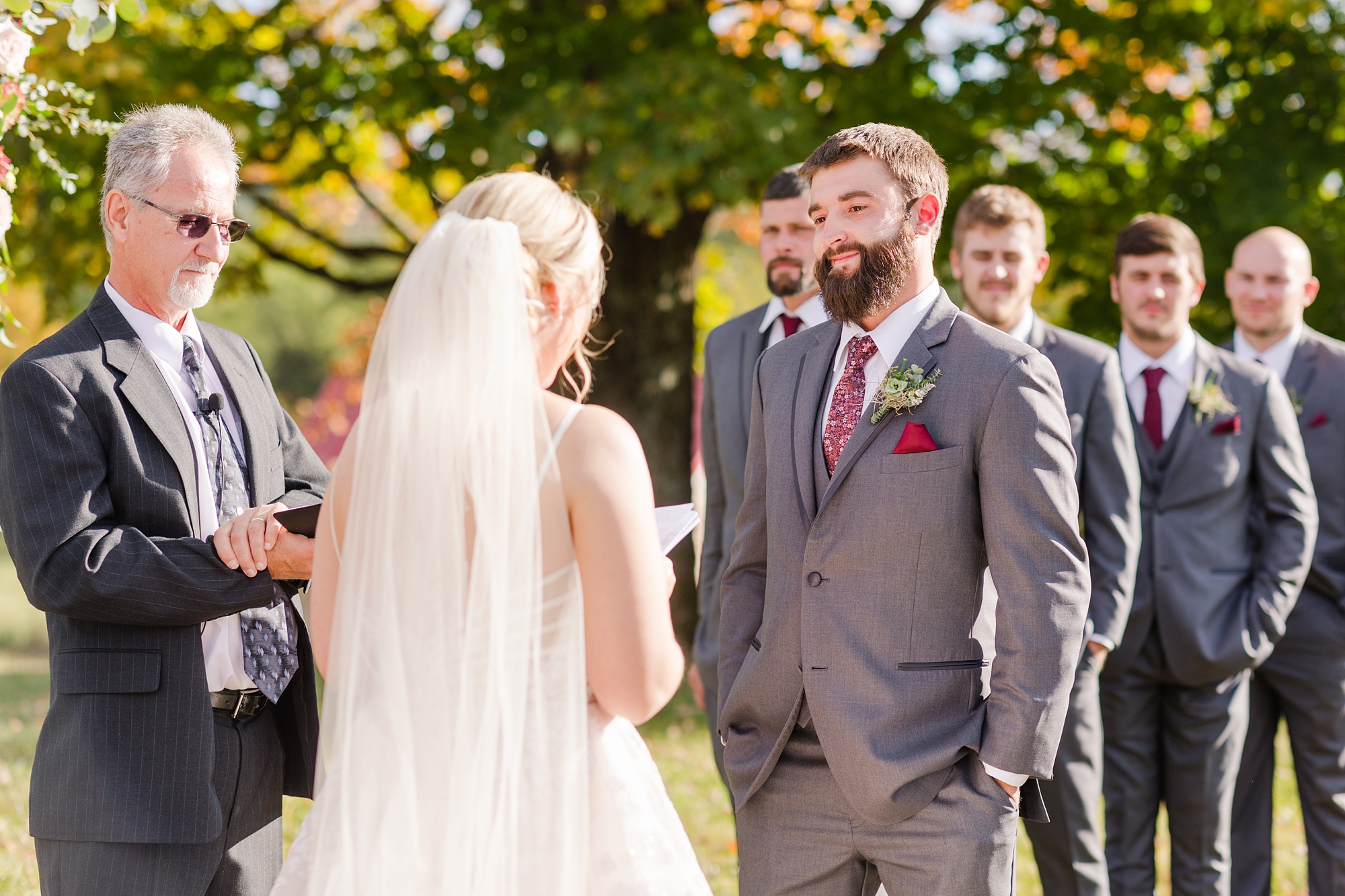 bride and groom exchange vows in outdoor fall wedding ceremony
