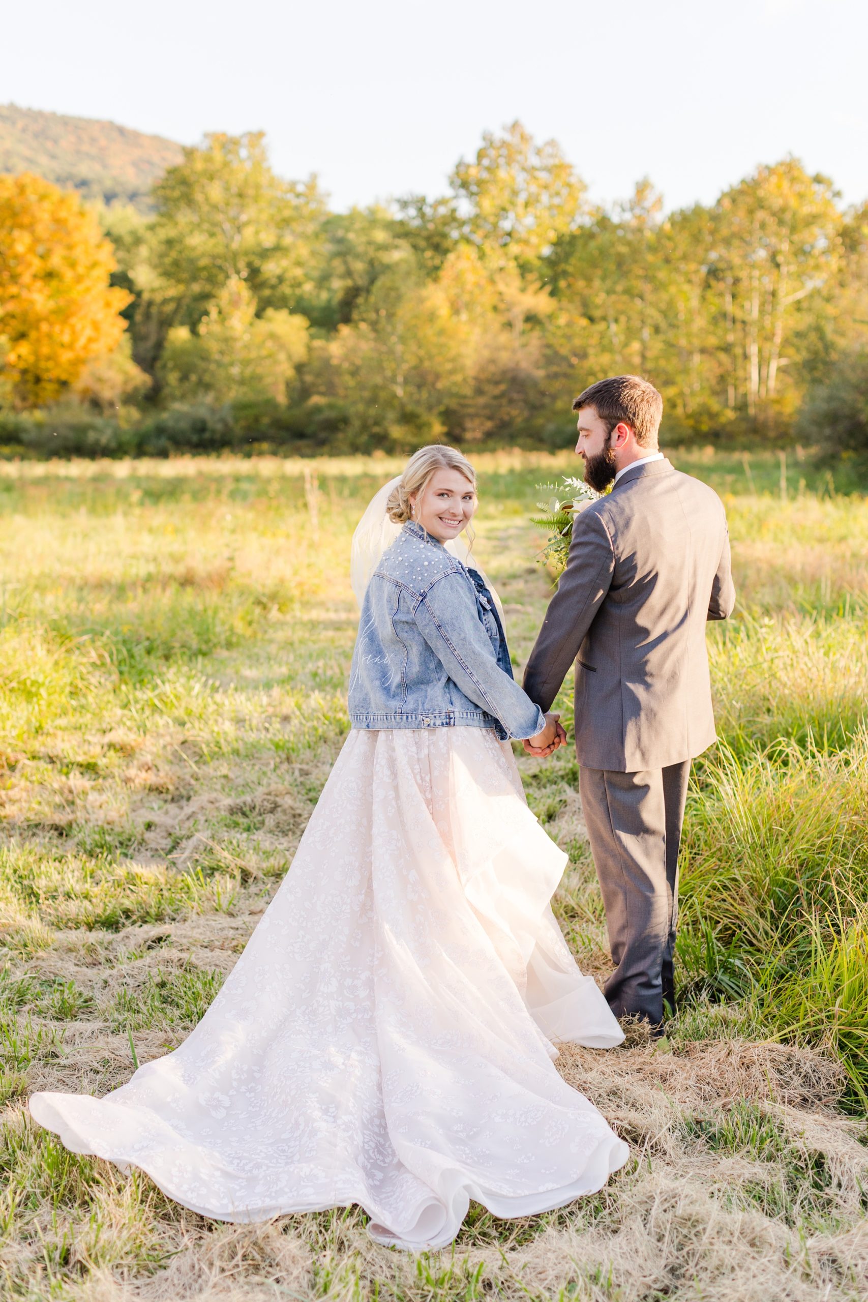 groom walks with bride in custom jacket